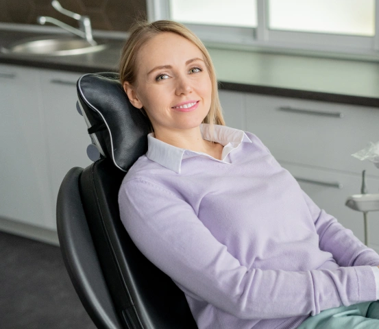 Female patient relaxing in a dental chair during a routine dental visit