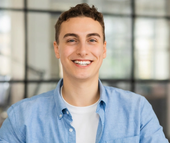 Smiling young man representing the qualities to consider when finding the best dentist