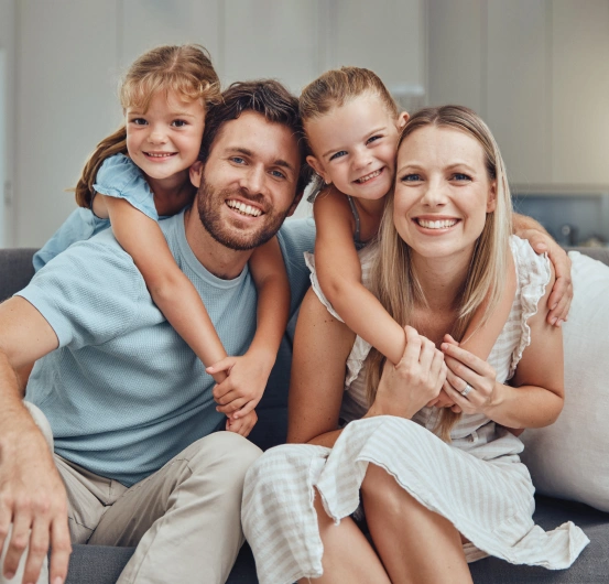 Family smiling together after receiving comprehensive dental care services